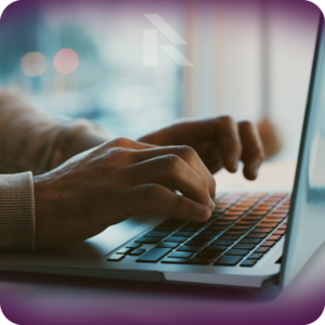 Close-up of hands typing on a laptop, symbolizing online car shipping booking.
