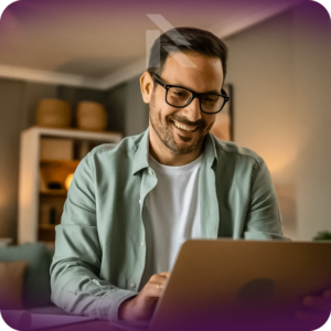 A man smiling while looking at his laptop, symbolizing a stress-free car shipping process.