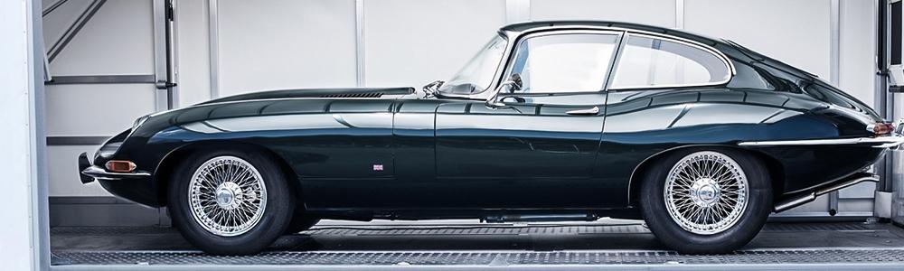 Jaguar E-Type classic car inside enclosed auto transport container